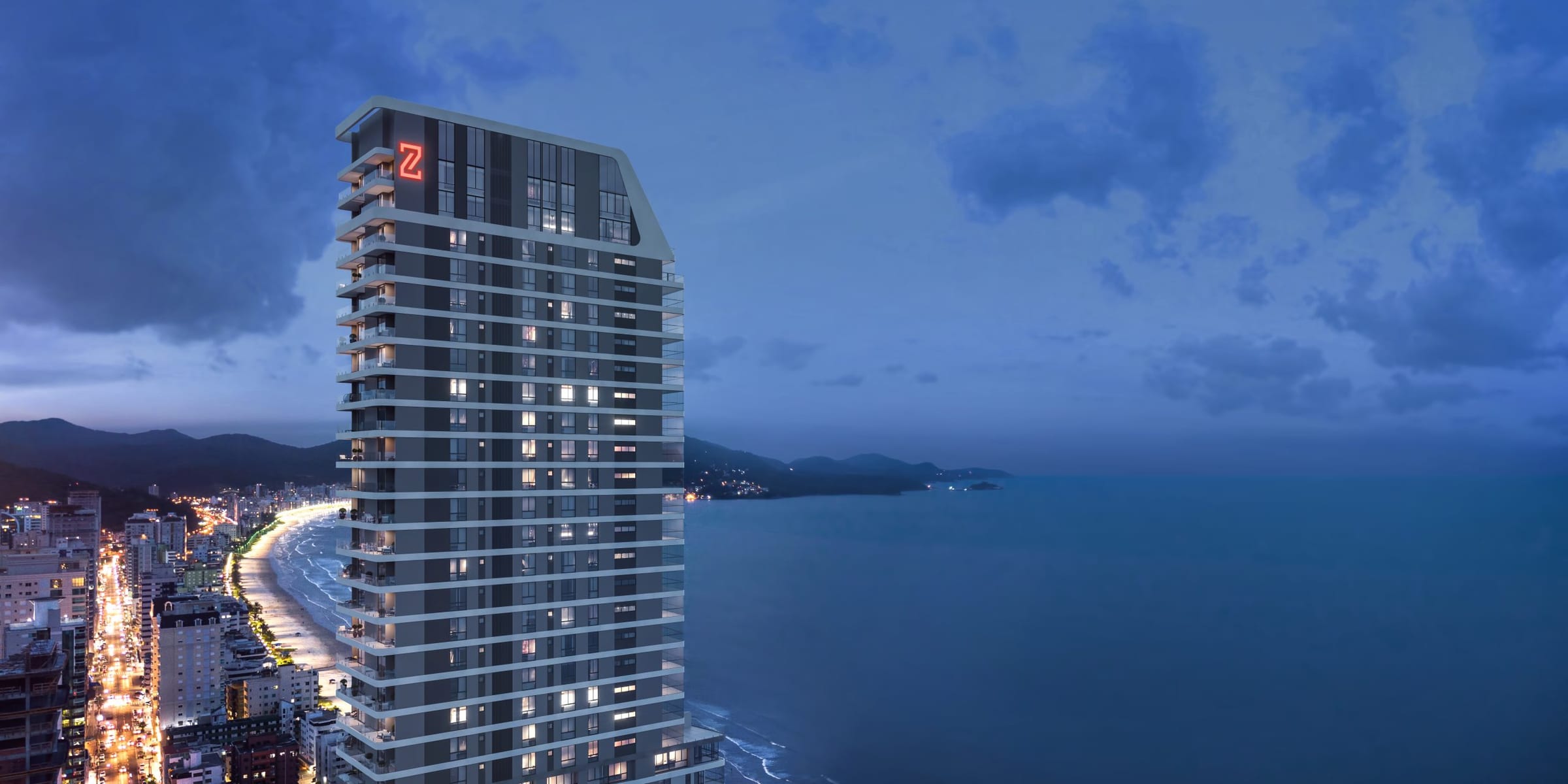 Vista aérea noturna da torre Legend Vila Rica iluminada, à beira-mar em Meia Praia, Itapema